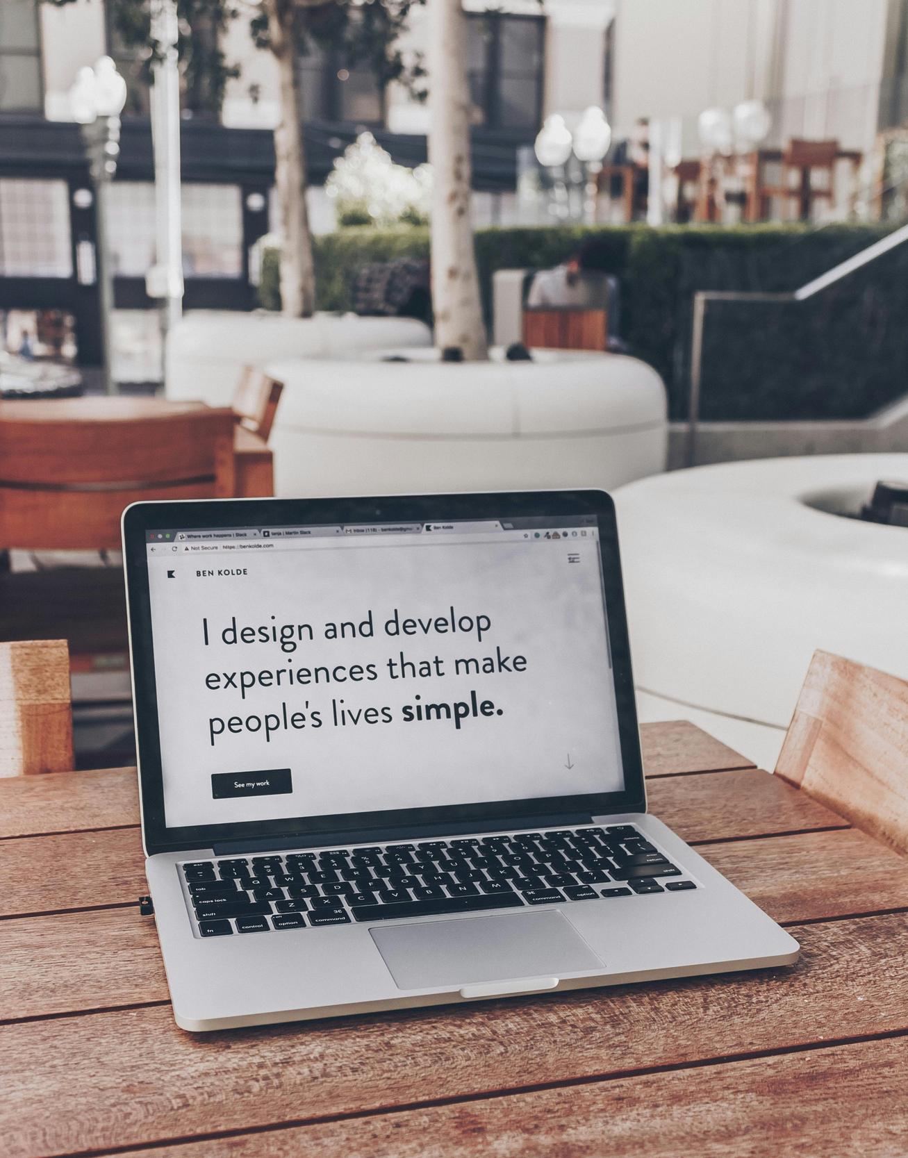 laptop with quote on screen saying: I design and develop experiences that make people's live simple